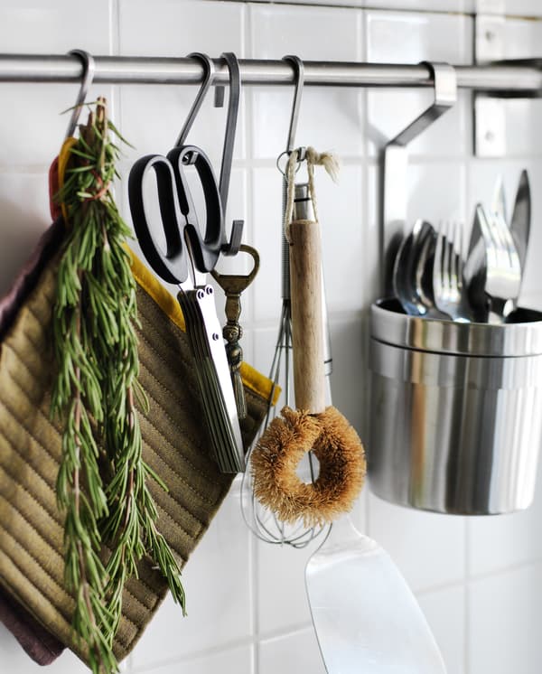 Hanging kitchen utensils on the wall keeps them within easy reach.