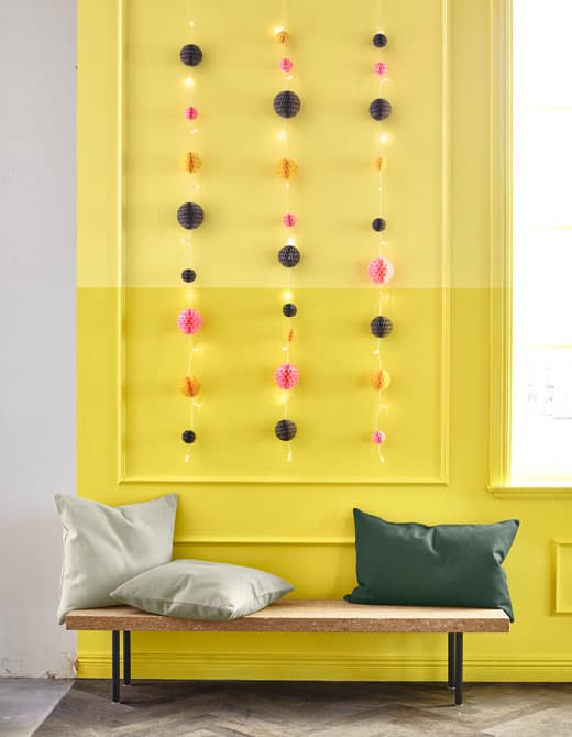 Hanging string lights make great party decorations, adding paper decorations is even better.