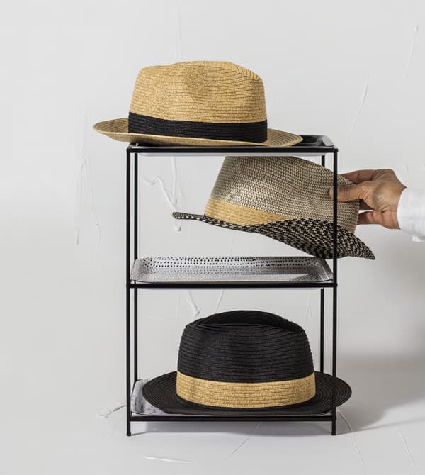 Hats displayed on a black stand.