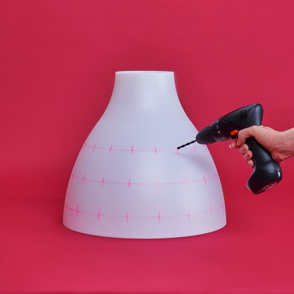 Holes are being drilled into the lamp.