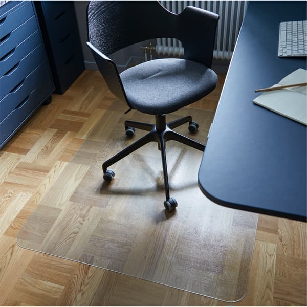 Home office with KOLON transparent floor protector protecting the floor beneath a conference chair and placed beside a desk. 