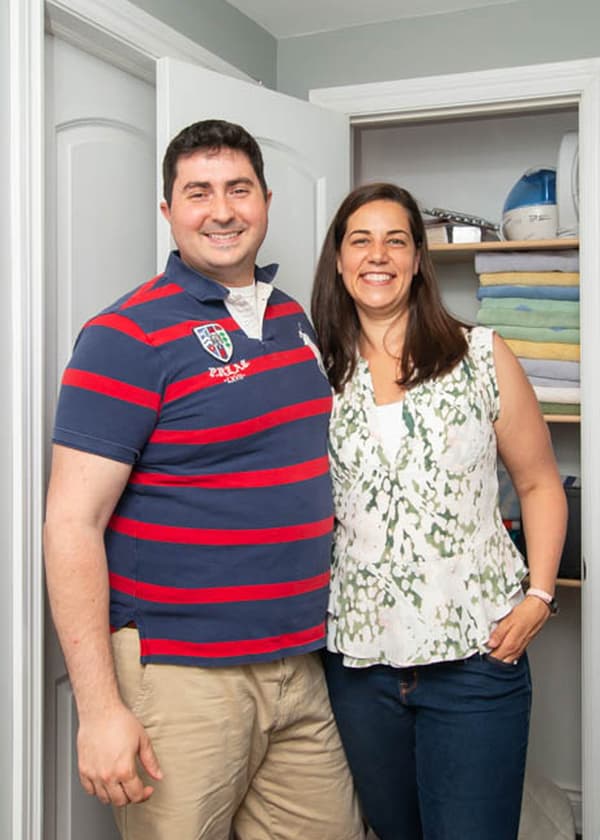 Homeowners Megan and Don, standing in front of their hallway linen closet.