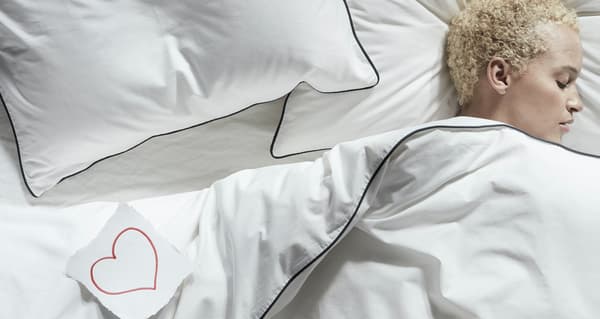 homme allongé sur le côté sous la couette
