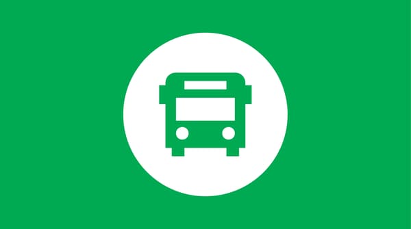 Icon of a bus on green background.
