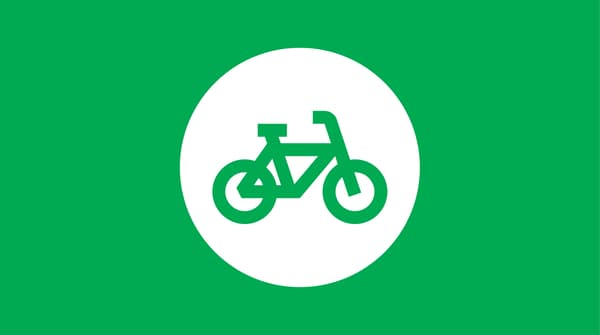 Icon of a bycicle on green background.