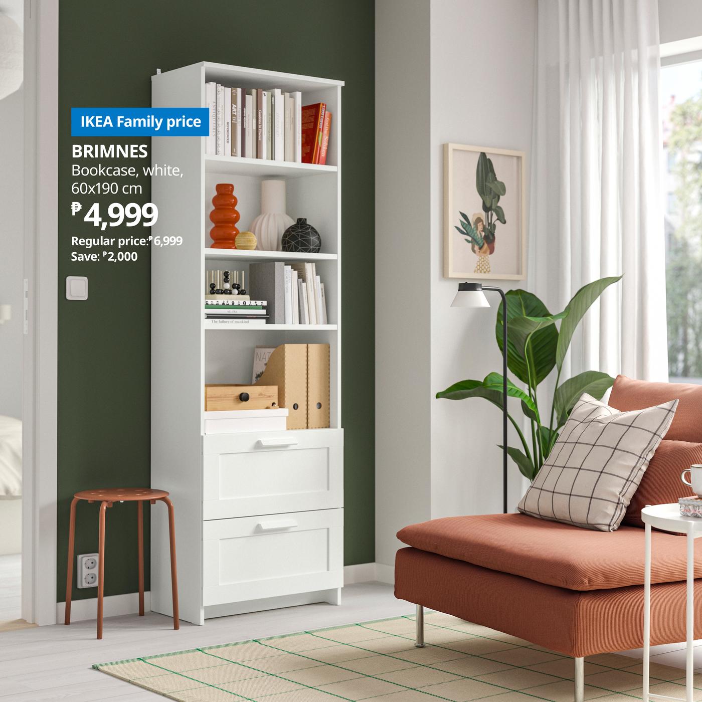 IKEA ad for a white BRIMNES bookcase, priced at 4,999, in a calm, sunlit living room beside a rust-colored sofa and leafy plant.
