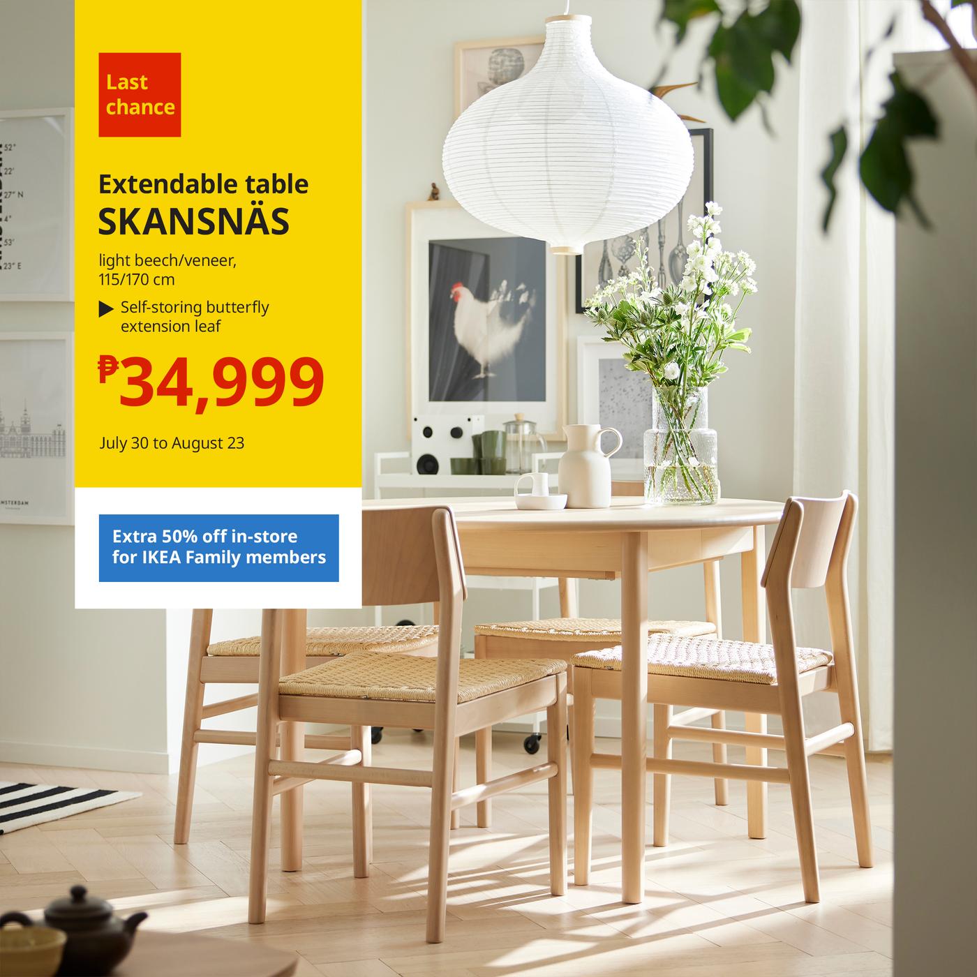 IKEA advertisement for a last-chance SKANSNÄS extendable table in light beech/veneer, 115/170 cm. The ad shows a bright dining room with a light wood table, four matching woven-seat chairs, a large white pendant lamp, and a glass vase of white flowers. Text advertises a price of ₱34,999, valid July 30 to August 23, with an extra 50% off in-store for IKEA Family members. The table features a self-storing butterfly extension leaf.