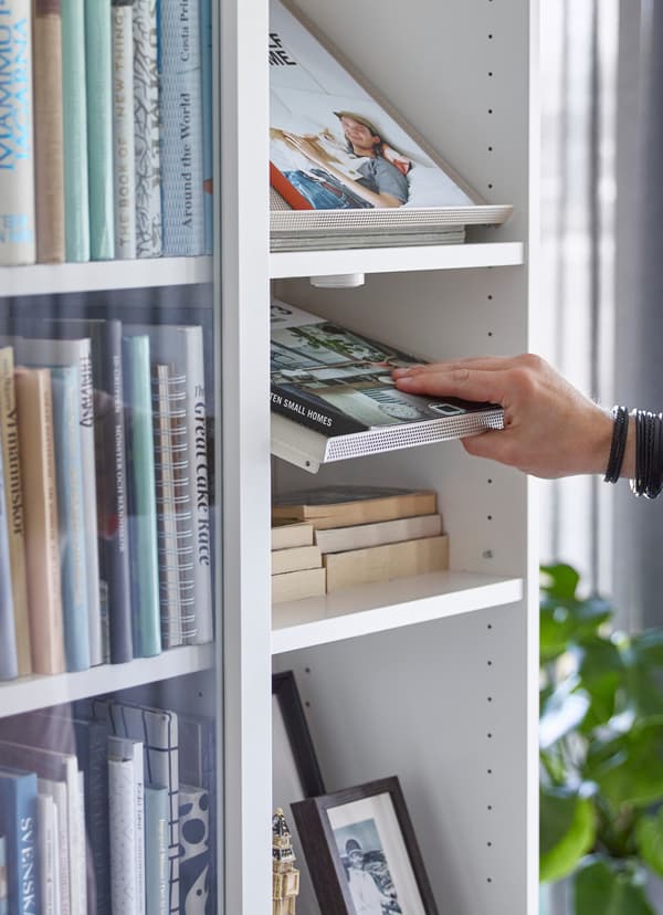 IKEA BOTTNA világos bézs bemutatópolcok egy fehér BILLY könyvespolcban.