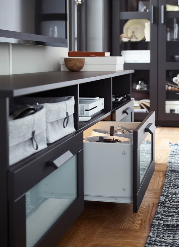 IKEA BRIMNES black tv bench with an open shelf, with integrated lighting inside.