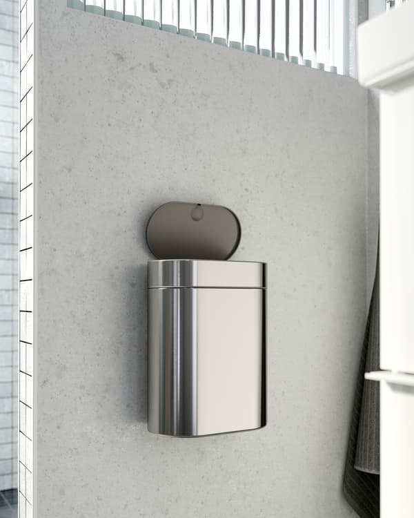 IKEA BROGRUND touch top bin in stainless steel that is mounted on a wall right next to the wash basin.