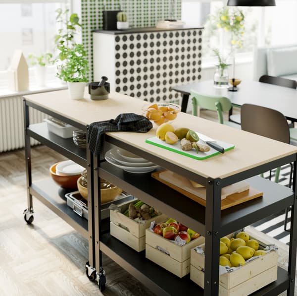 IKEA BROR black trolley with a light pine and plywood countertop, storing KNAGGLIG pine boxes on its two shelves.