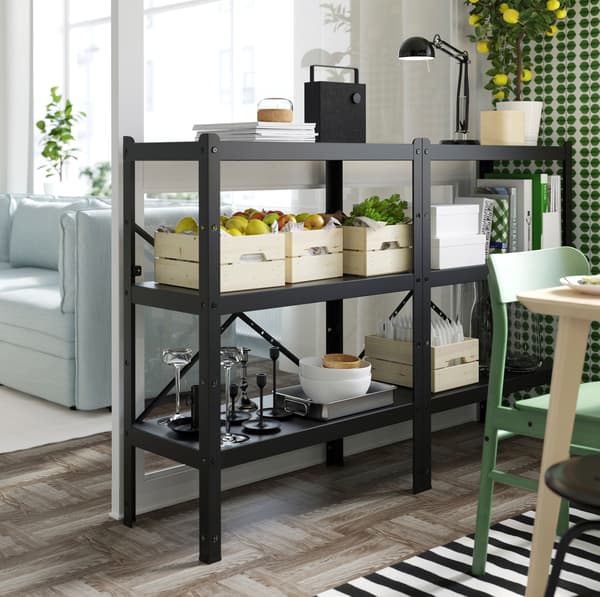 IKEA BROR shelving unit with a black frame, pine and plywood surface, storing KNAGGLIG pine boxes.