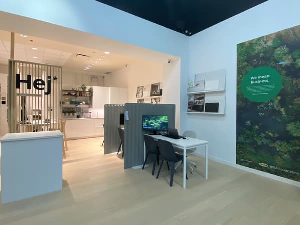 IKEA Canada Planning Studio interior shows work station, artwork on the wall and room setting in background.
