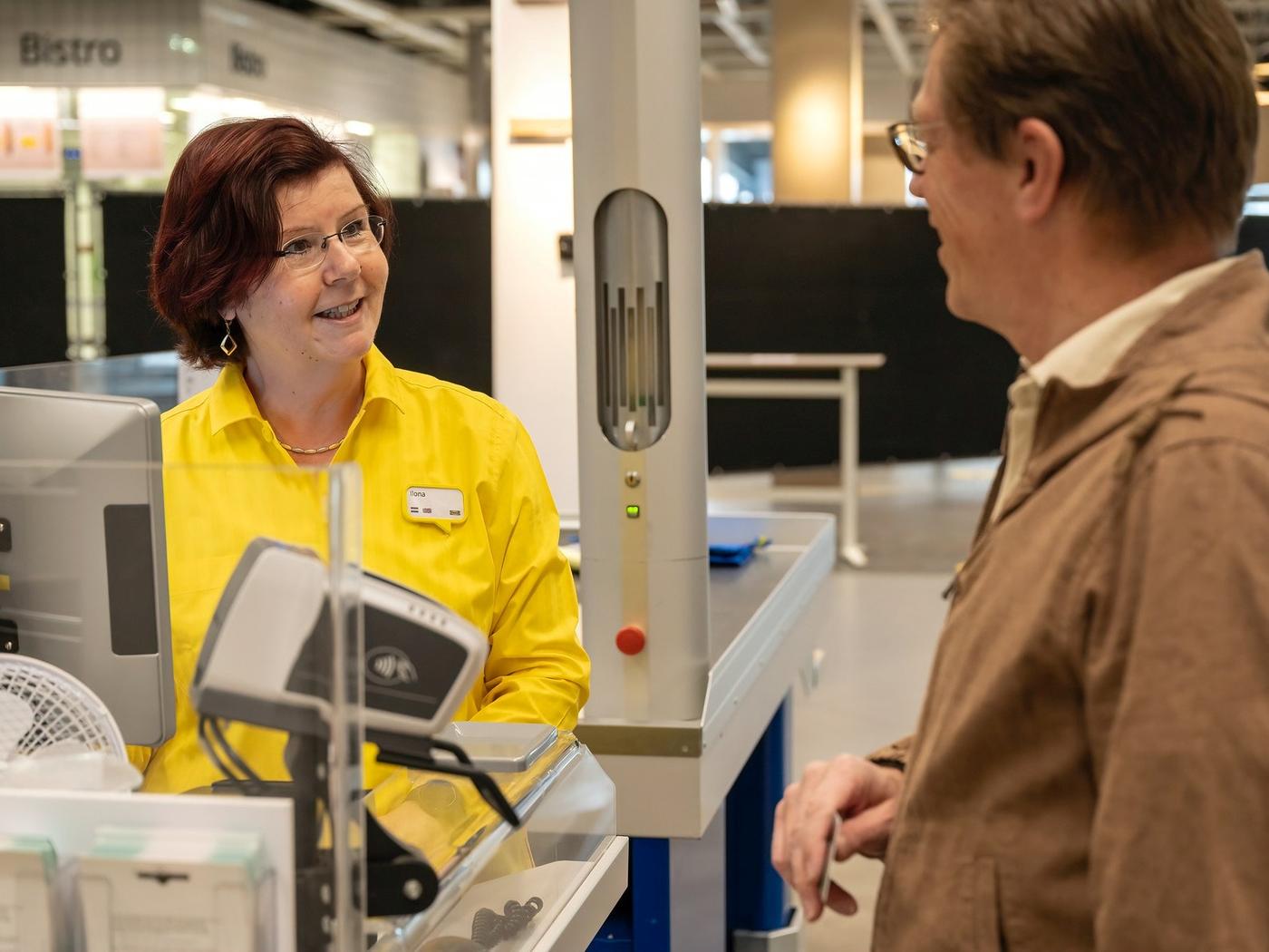 IKEA co-worker service a customer at checkout