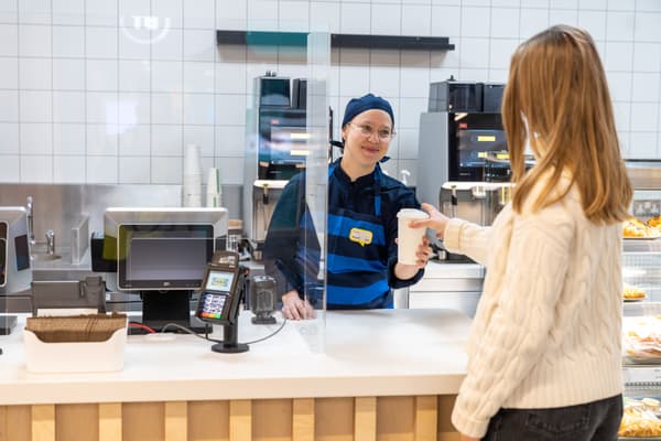 IKEA co-worker serving a take away coffe to a customer