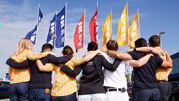 IKEA co-workers facing the flag poles
