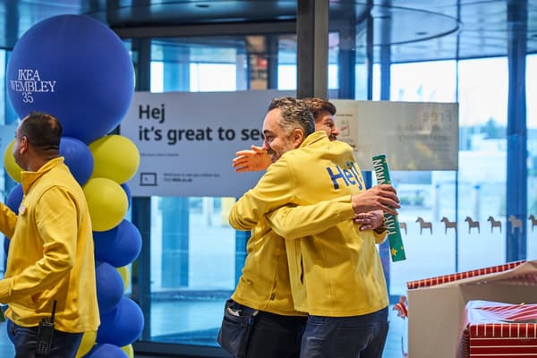 IKEA co-workers in yellow uniforms hugging and smiling