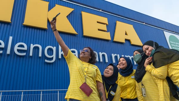 IKEA co-workers taking a photo in front of the store.