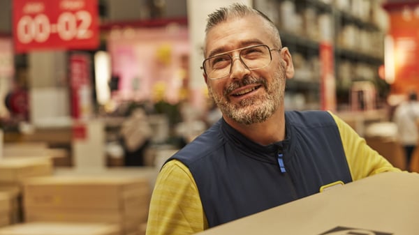 IKEA Coworker caring an IKEA brown box