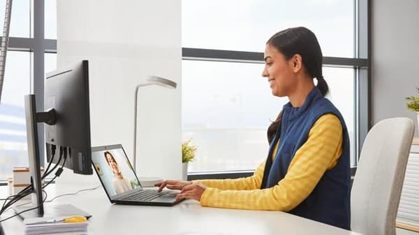 IKEA coworker sitting at a desk on the computer