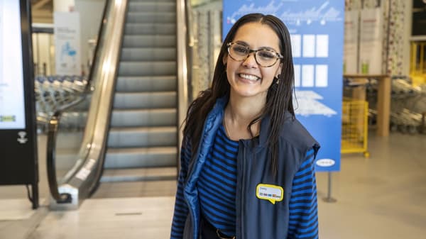 IKEA coworker smiling at the store entrance 