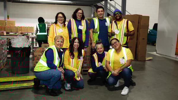 IKEA Coworkers posing for a picture in an IKEA warehouse