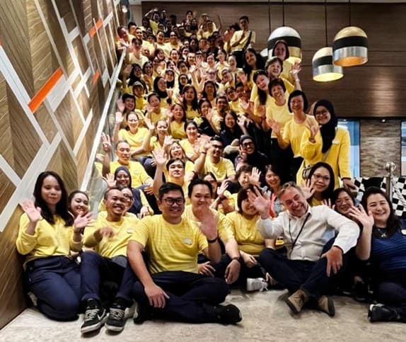IKEA coworkers posing with their plaques to commemorate their achievement