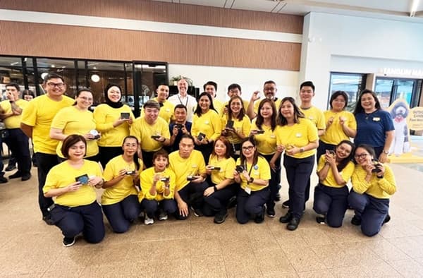 IKEA coworkers posing with their plaques to commemorate their achievement