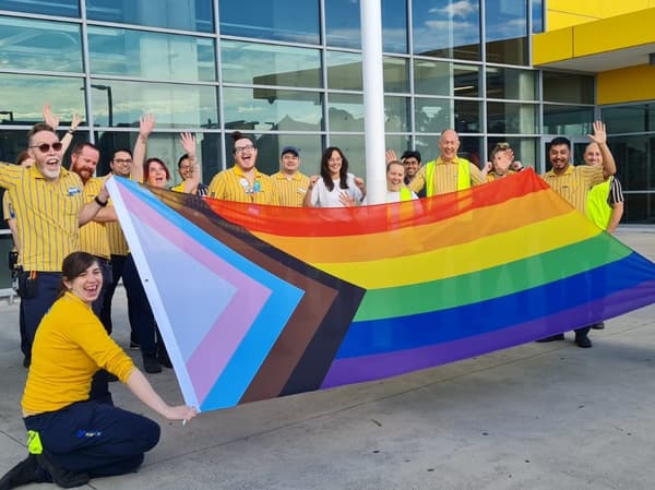ikea coworkers with rainbow flag