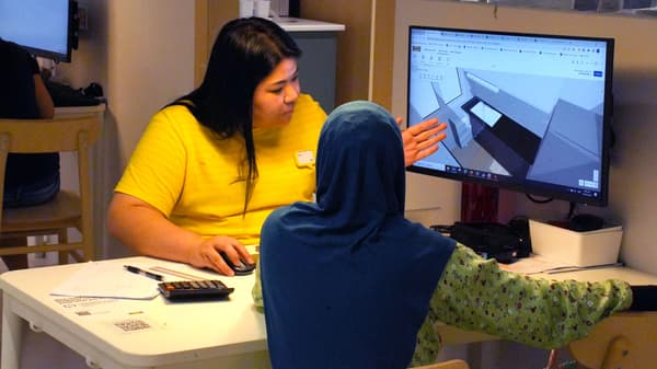 IKEA customer service officer supporting customer in planning process in an IKEA store.