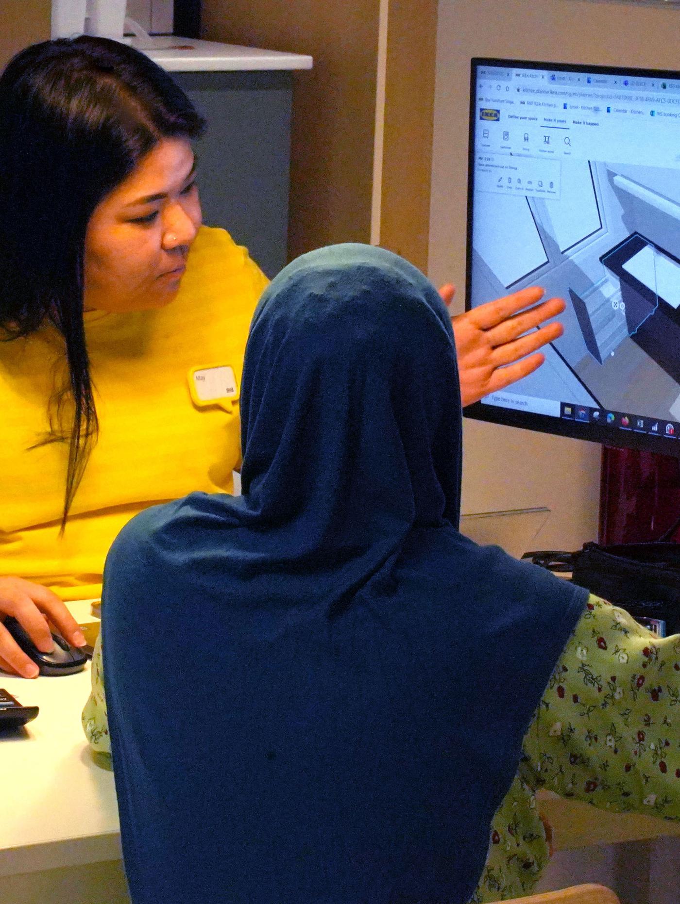 IKEA customer service officer supporting customer in planning process in an IKEA store.