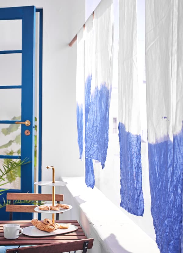 IKEA DITTE white sustainable cotton fabric tthat was dip-dyed in a bright blue gradient pattern.