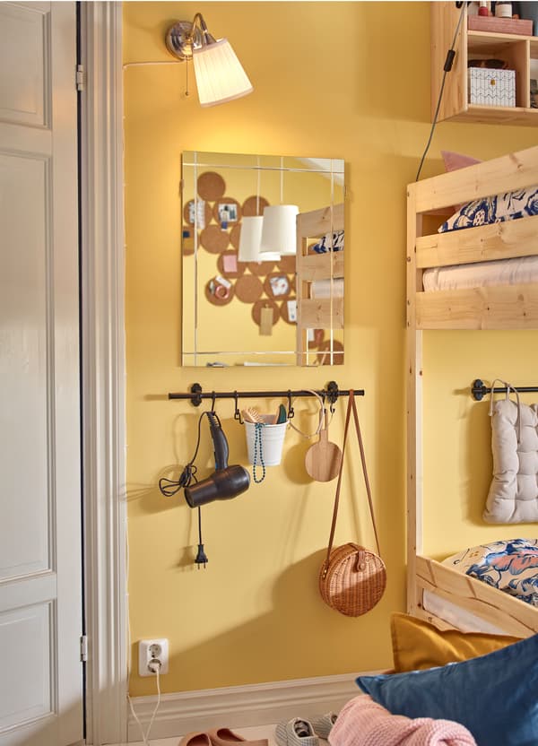 IKEA EIDSÅ square glass mirror and ÅRSTID nickel-plated wall lamp mounted close together to create a getting ready station.