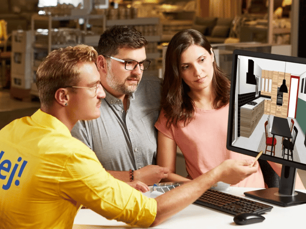 IKEA employee helps customers with kitchen planning