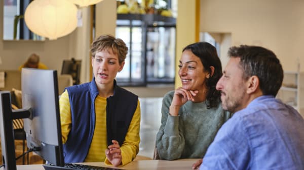 IKEA employee helps customers with planning 