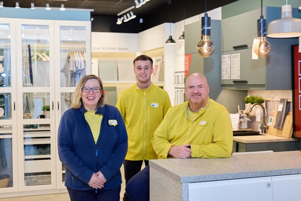IKEA employees ready for a picture in kitchen setup