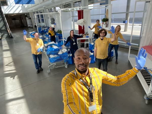 IKEA employees with carts of donated items.