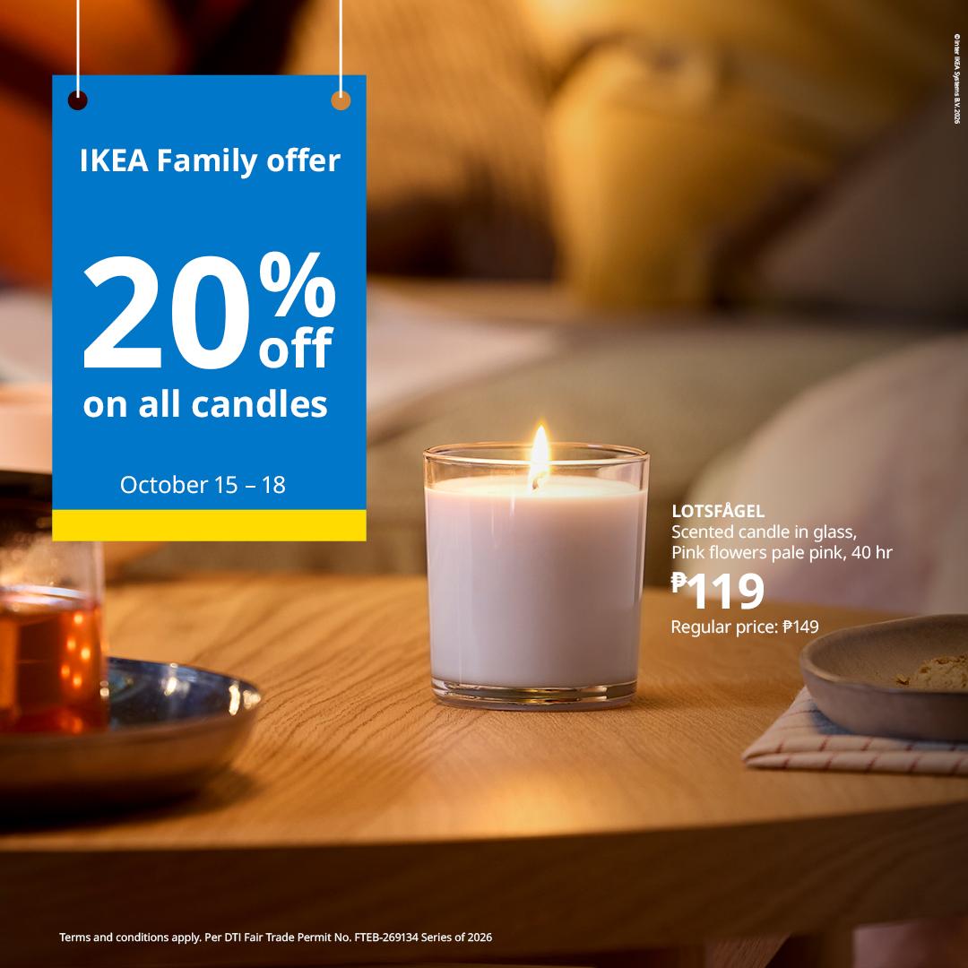 IKEA Family ad showing a lit pink scented candle on a warm wooden table beside tea, with a blue sign offering 20% off candles, October 15–18.