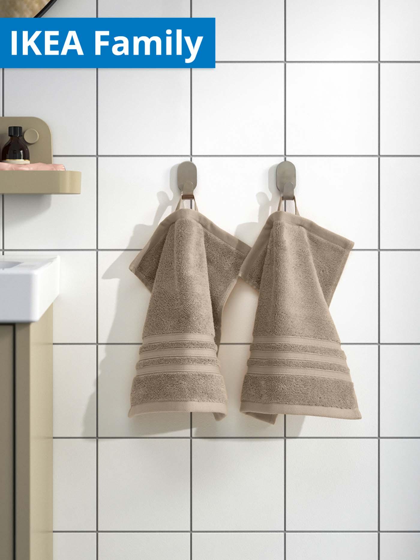 IKEA Family offer. Beige BROKGLIM hand towel hanging in bathroom.
