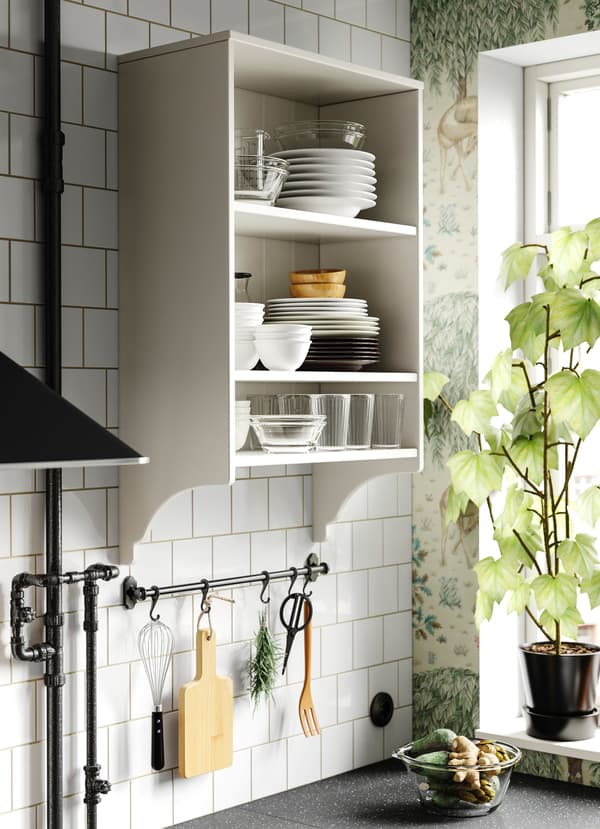 IKEA FINTORP black rail with black hooks hanging essential kitchen utensils.