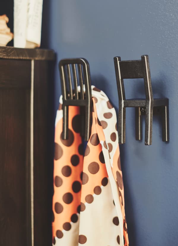 IKEA FJANTIG black chair shaped hooks can be mounted to the wall to add a bit of playfulness to your home.