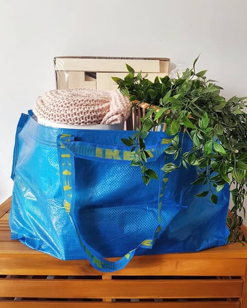 IKEA FRAKTA bag on table filled with products