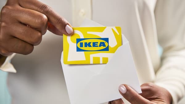 IKEA gift card being placed into a white envelope