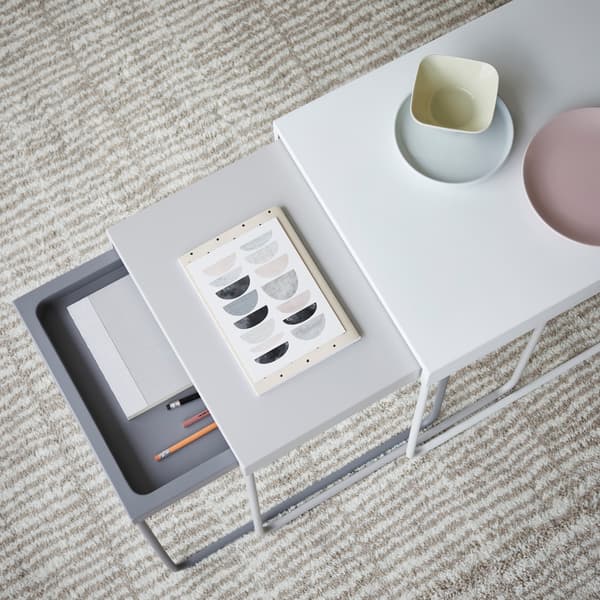 IKEA GRANBODA metal stained nesting tables, with stationary and small plates on top of them.