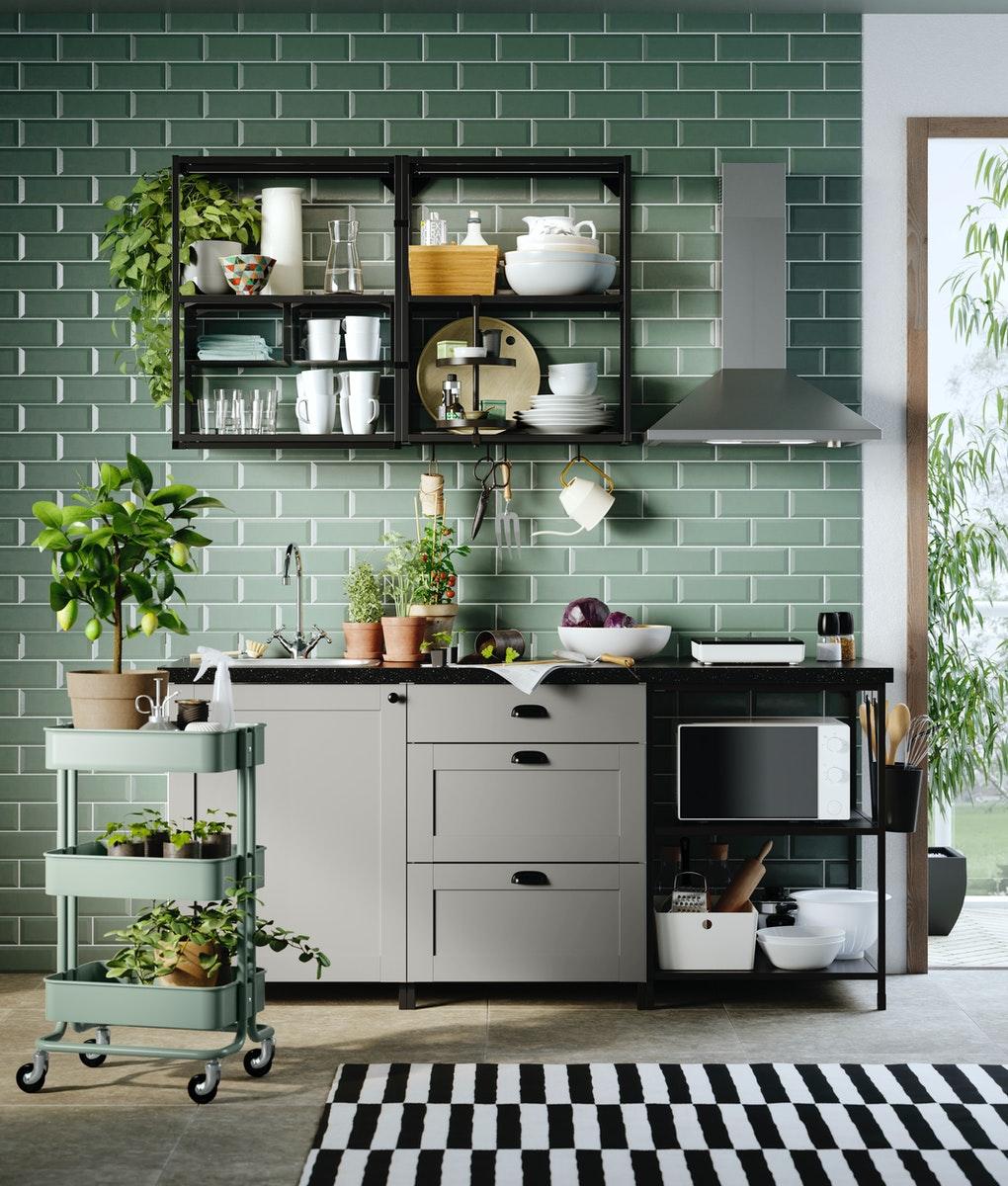 IKEA grey shaker ENHET kitchen and dark worktop with a green tiled wall and wood floor