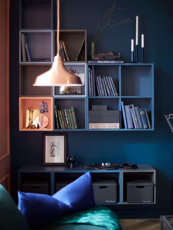 IKEA has a variety of open cabinets for wall storage like EKET cabinets. You can group the square cabinets how you want.