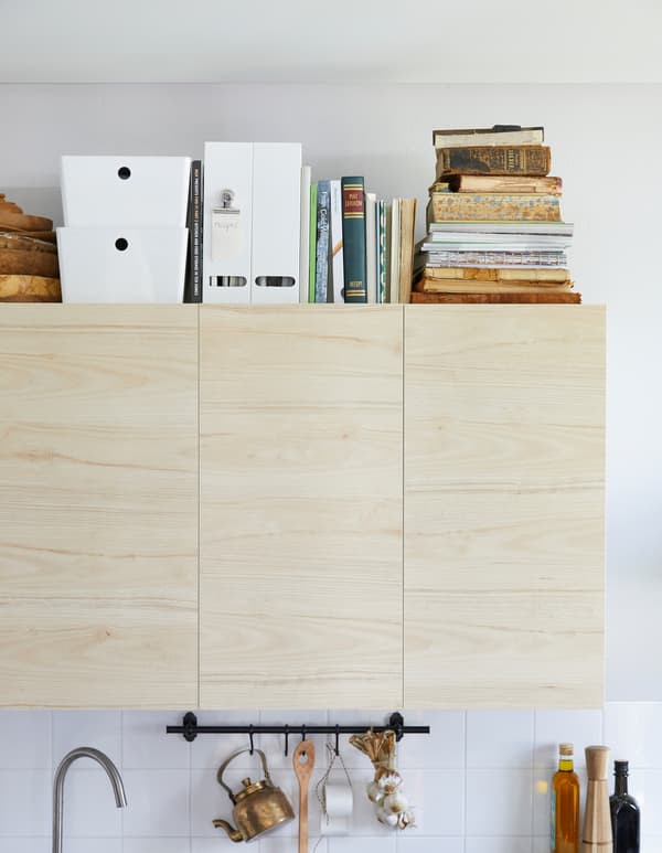 IKEA has products that can be recipe boxes like KUGGIS box with lid in durable, white recycled PET plastic. The boxes can be stacked on top of each other. We put them alongside cookbooks above kitchen cabinets to make a recipe library.