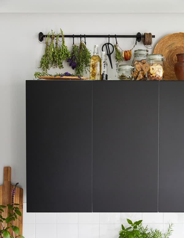 IKEA has products to make an herb drying rack like this one in the space above kitchen cabinets. You can use rustic-style FINTORP rail with black powder-coated steel and zinc. Tie bundled herbs on the railk or on hooks.