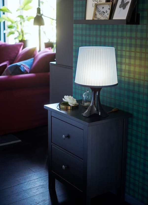 IKEA HEMNES black brown beside table used in the hallway of a small living area space, with a table lamp placed on top.