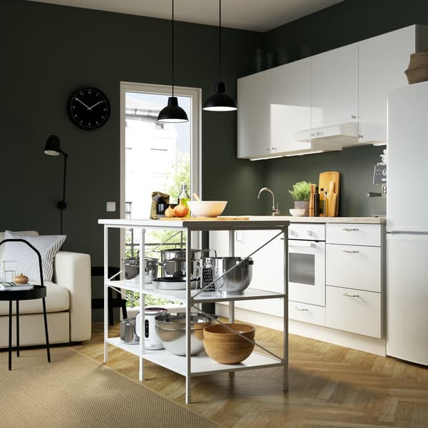 IKEA high gloss white ENHET kitchen and worktop with a green wall and wood floor